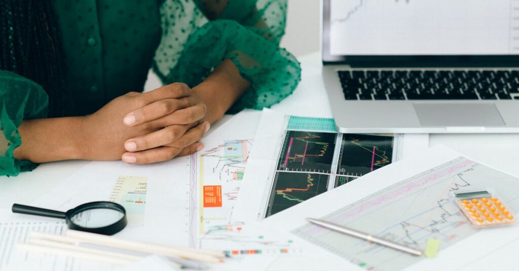 A person analyzing financial charts and graphs at a desk, representing insights into why digital marketing is essential for business growth.